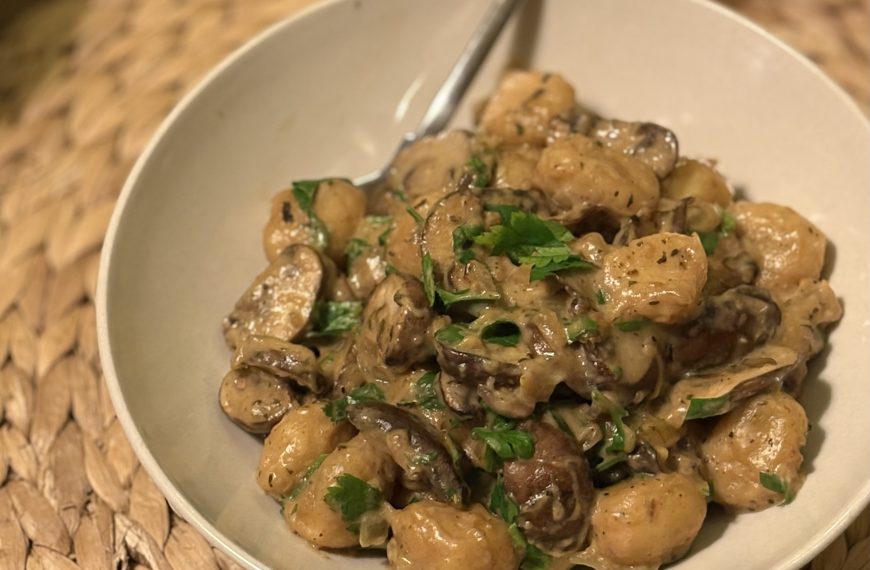 a plate with creamy gnocchi with mushrooms and parsley