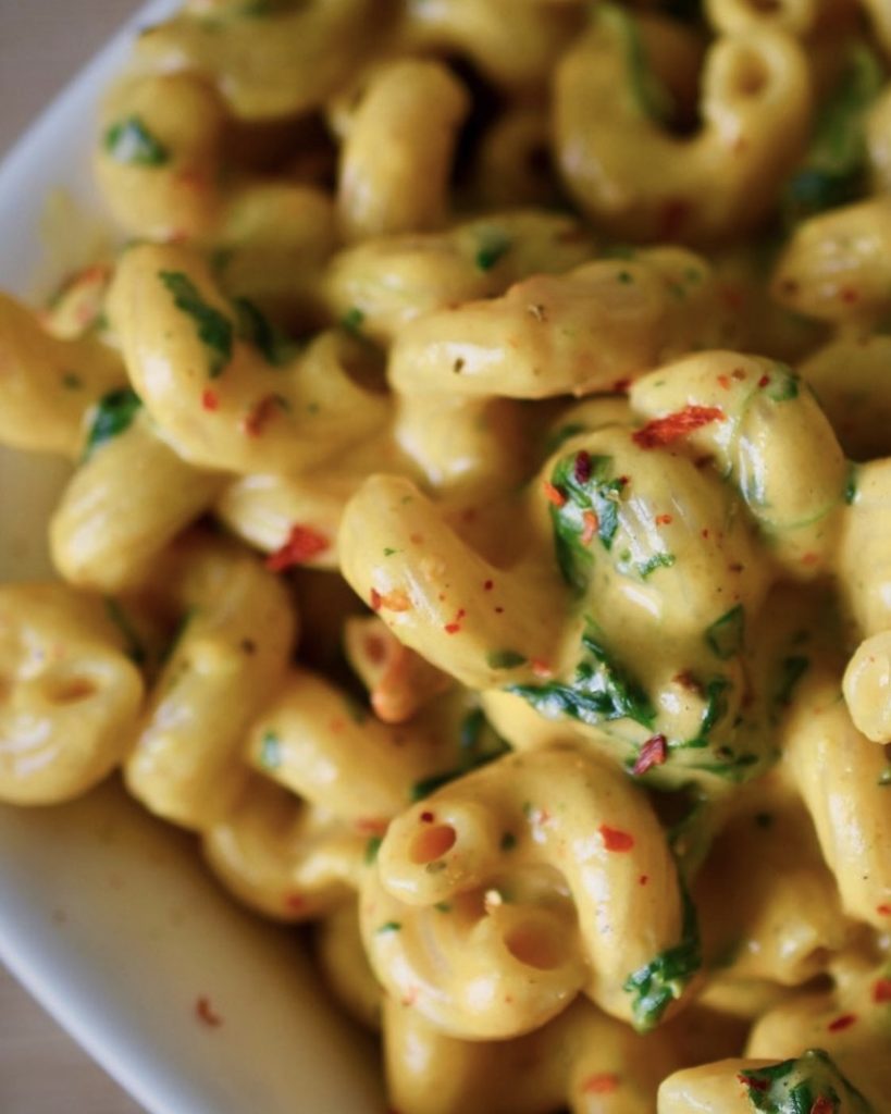 close-up of creamy vegan Mac and cheese with spinach